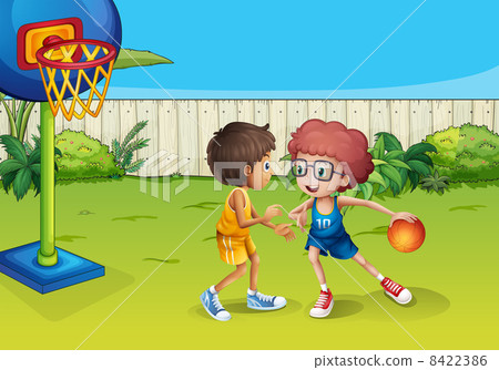 Two boys playing basketball inside the fence 8422386