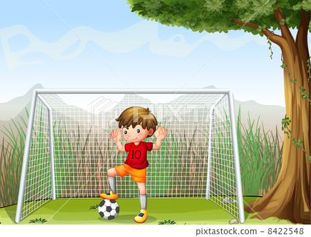 A young football player near the big tree 8422548