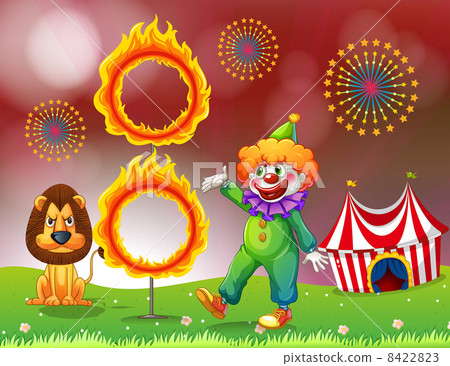 A carnival with a clown and a lion near the ring of fire 8422823