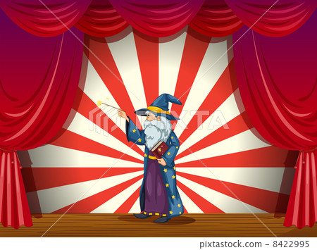 A wizard holding a wand in the middle of the stage A wizard holding a wand in the middle of the stage 8422995
