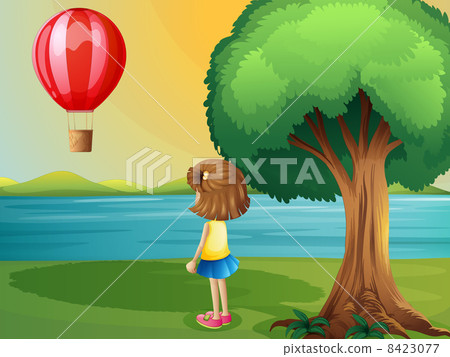 A girl watching the hot air balloon at the riverbank A girl watching the hot air balloon at the riverbank 8423077