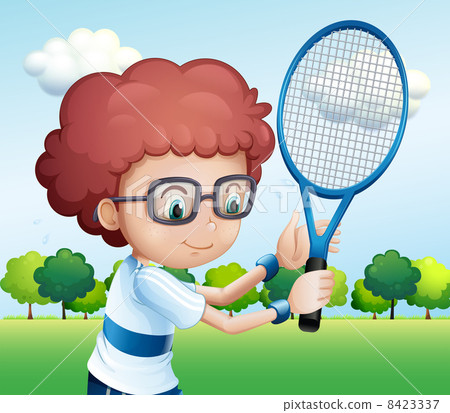A young boy playing tennis 8423337