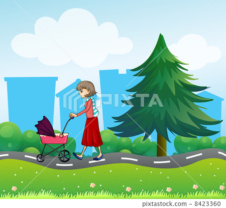A girl with a baby stroller along the road 8423360