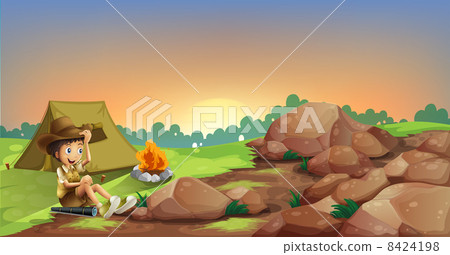 A young boy camping near the rocks 8424198