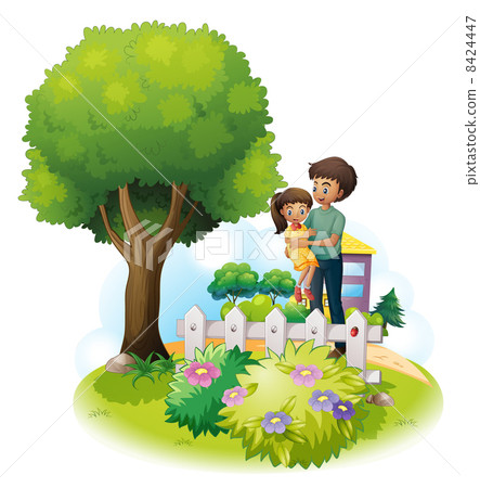A father and his daughter near the wooden fence and the giant tr 8424447