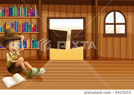 A young boy reading inside the room with a swingdoor A young boy reading inside the room with a swingdoor 8425033