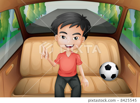 A boy inside the car with a soccer ball 8425545