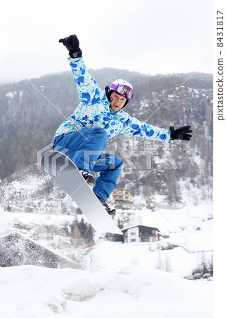 Snowboarder in helmet and sport suit jumps on snowboard on mount Snowboarder in helmet and sport suit jumps on snowboard on mount 8431817