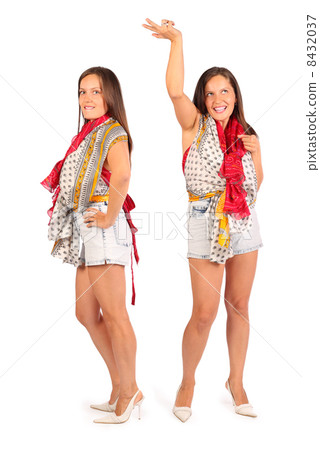 Two same happy women wearing in shorts dance in studio on white 8432037