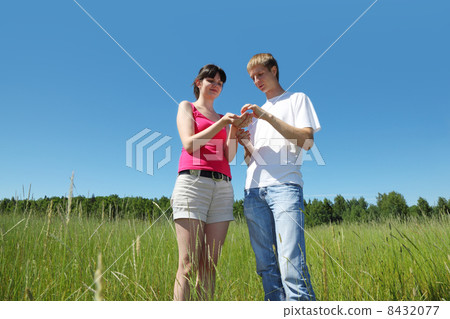 husband, wife look on berry in wife hands near forest 8432077