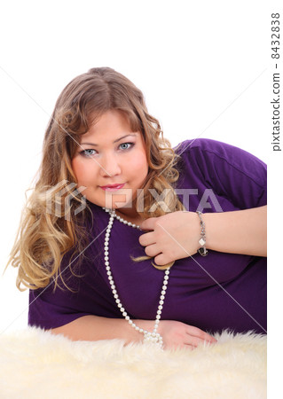 Smiling beautiful woman lies on white fur isolated on white back 8432838