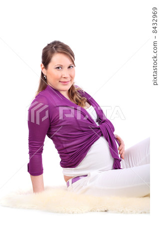Young pregnant woman sits on white fur isolated on white backgro Young pregnant woman sits on white fur isolated on white backgro 8432969