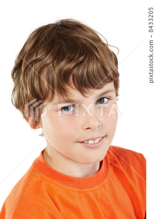 Close-up portrait of boy in orange T-shirt 8433205