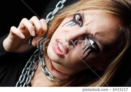 Evil zombie girl with black tears and cut throat hangs on chain Evil zombie girl with black tears and cut throat hangs on chain 8433217