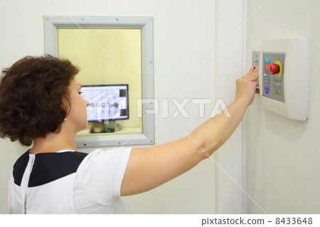 Back of dentist pressed button X-rays to image teeth outside iso 8433648