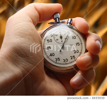 Hand with stopwatch on insulated cords background Hand with stopwatch on insulated cords background 8435030