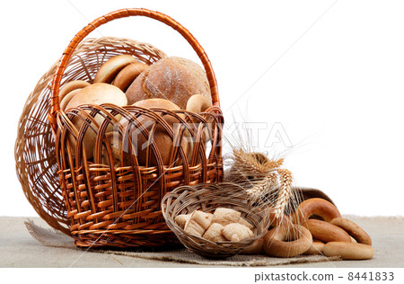 Fresh bread with ears of wheat on a wooden table. 8441833