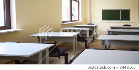 Empty beige classroom with wooden school desks and simple black Empty beige classroom with wooden school desks and simple black 8448165
