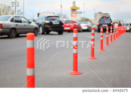 protective barrier made of red striped columns on road, focus on protective barrier made of red striped columns on road, focus on 8448975