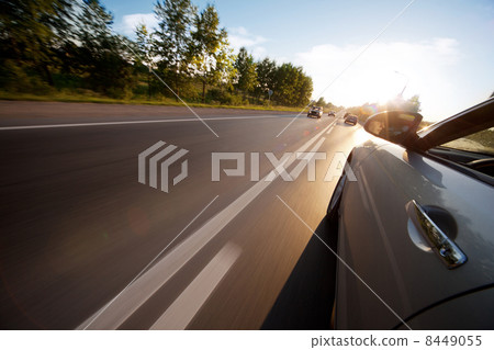 Car ride on road in sunny weather, motion blur 8449055
