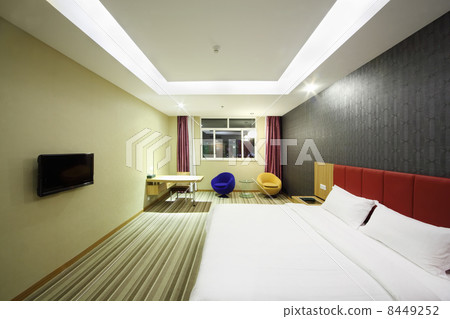 Double soft bed with clean white linen in stylish light room. 8449252