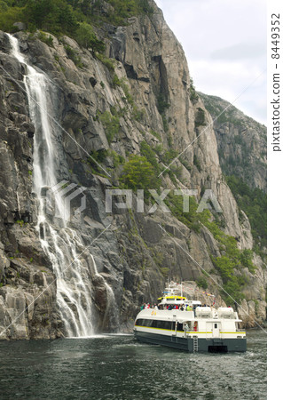 Bergen - JUL 28: People on tour on small boat near waterfall on Pulpit Rock on Jul 28, 2011 in Bergen, Norway. Pulpit Rock attend two million tourists every year. Bergen - JUL 28: People on tour on small boat near waterfall on Pulpit Rock on Jul 28, 2011 in Bergen, Norway. Pulpit Rock attend two million tourists every year. 8449352