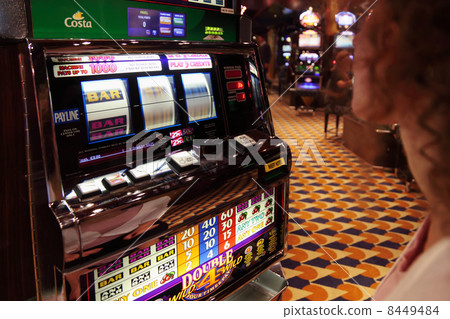 NORTH SEA - JULE 29: Woman looks at slot machine at liner Costa NORTH SEA - JULE 29: Woman looks at slot machine at liner Costa 8449484