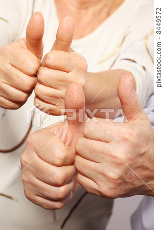 senior couple show big finger, good gesture senior couple show big finger, good gesture 8449572