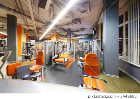 Empty gym with orange exercise equipment. Sports - part of healt Empty gym with orange exercise equipment. Sports - part of healt 8449693