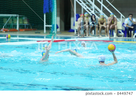 MOSCOW - MARCH 3: Men play water polo in pool, spectators, judge 8449747