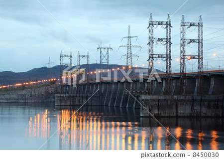 Hydroelectric power station on river at evening, posts with high 8450030