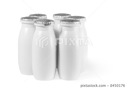 white plastic bottle with foil cap, date with yogurt stand on table 8450176