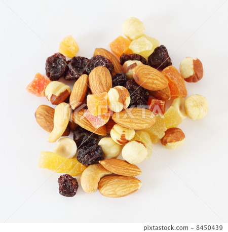 Handful of nuts, dried fruits and candied fruits on white backgr 8450439
