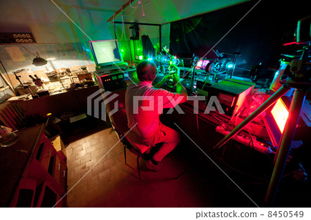 Scientist seat on chair and research in his lab about movement of microparticles by laser 8450549