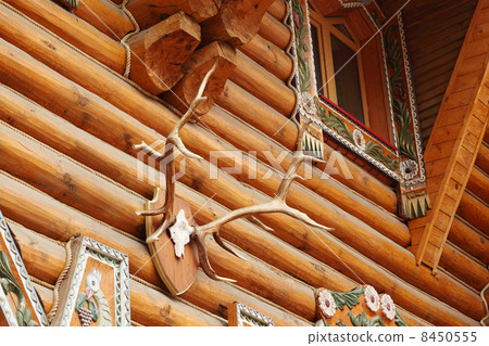 Fragment of large wooden house with carved decoration and deer h 8450555