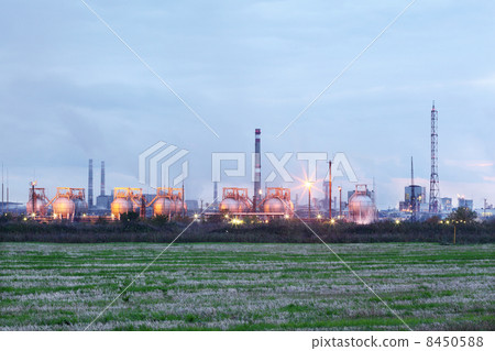 Industrial zone with factories and pipes with smoke and illumina 8450588