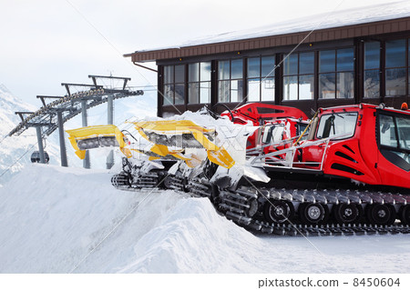 Two red machines for skiing slope preparations in Austrian Alps. Two red machines for skiing slope preparations in Austrian Alps. 8450604