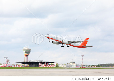 Large red and white passenger airplane takes off at airport. 8450618