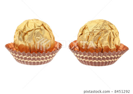 Two chocolate candies wrapped in gold. On a white background. 8451292