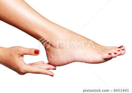 Closeup photo of a female feet with beautiful red pedicure Closeup photo of a female feet with beautiful red pedicure 8451491