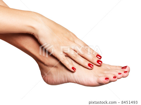 Closeup photo of a female feet with beautiful red pedicure 8451493