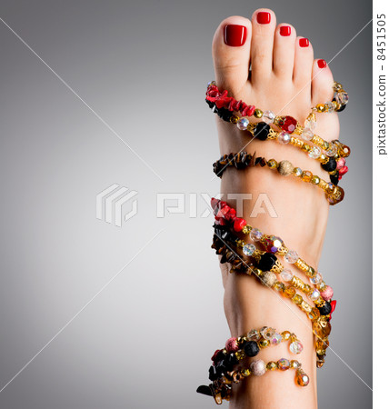 Beautiful female feet with red pedicure 8451505