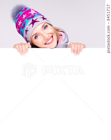 Happy woman in winter outerwear over white banner 8451717