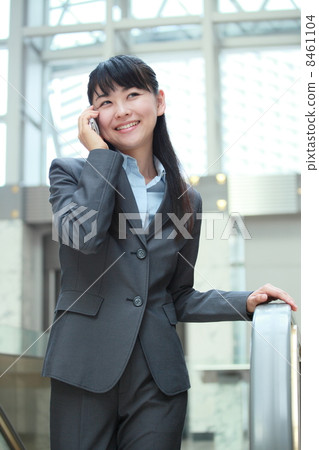 Business woman who climbed the escalator Business woman who climbed the escalator 8461104