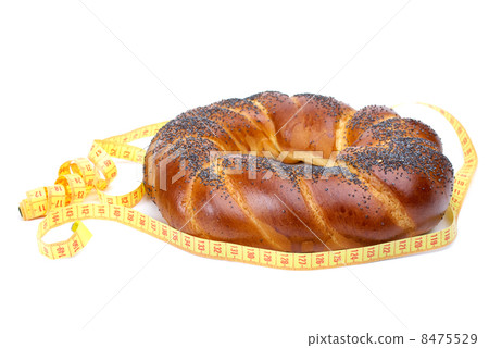 Ring shaped fancy loaf with poppyseeds and measurement tape Ring shaped fancy loaf with poppyseeds and measurement tape 8475529