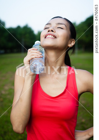 Asian Woman Cooling Off With Water Bottle 8476063