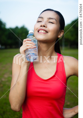 Asian Woman Cooling Off With Water Bottle 8476064