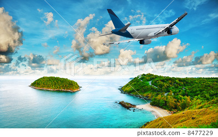 Jet is over the tropical resort in the morning 8477229