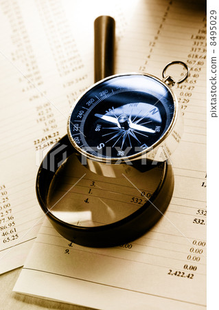 Operating budget, magnifying glass and black compass Operating budget, magnifying glass and black compass 8495029