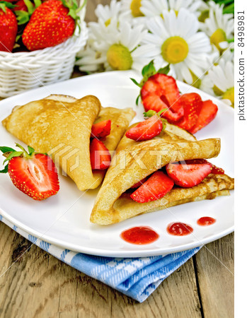 Pancakes with strawberries and jam on the board Pancakes with strawberries and jam on the board 8498981